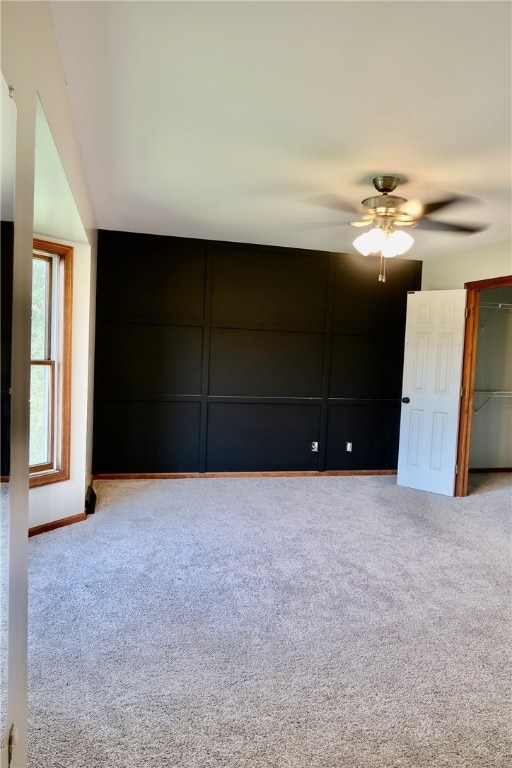 carpeted empty room with ceiling fan