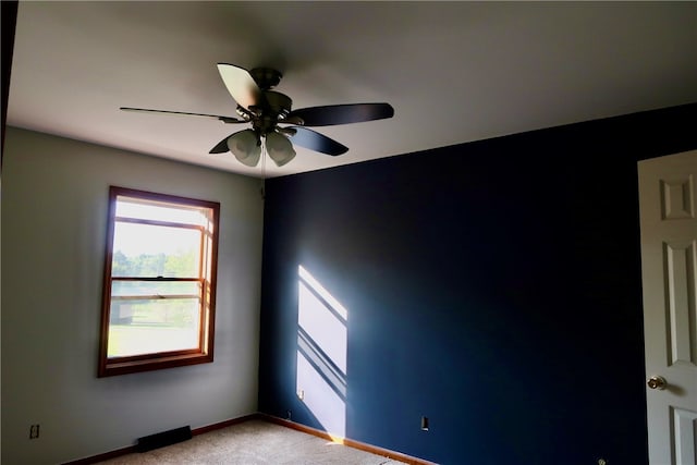 unfurnished room with ceiling fan and light colored carpet