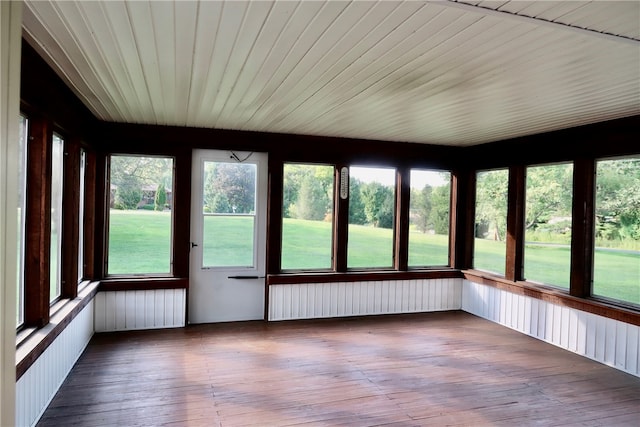 unfurnished sunroom with a healthy amount of sunlight and radiator heating unit