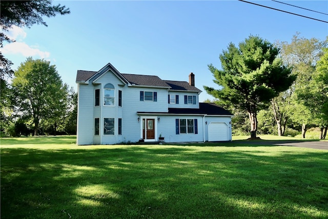 view of front of property with a front lawn and a garage