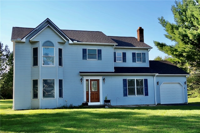 view of front of property featuring a garage and a front lawn