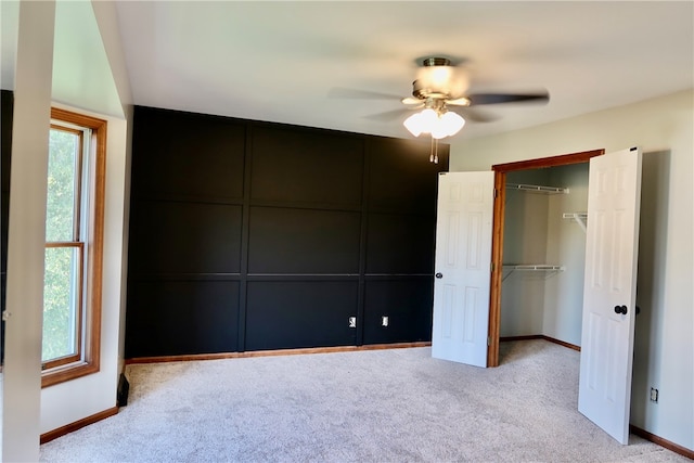 unfurnished bedroom with light colored carpet and ceiling fan