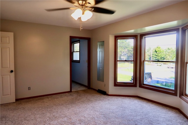 spare room with light carpet and ceiling fan