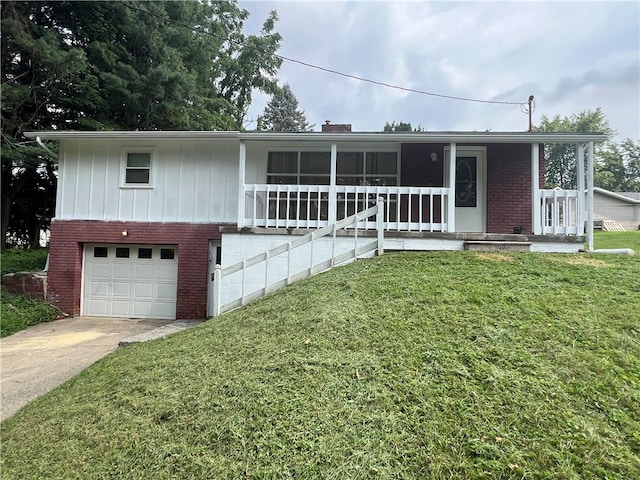 view of front of home featuring a porch, a front yard, and a garage