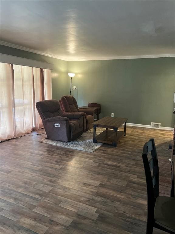 living room featuring dark hardwood / wood-style flooring and crown molding