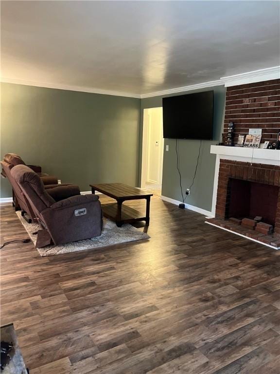 living room featuring dark hardwood / wood-style flooring, ornamental molding, and a fireplace