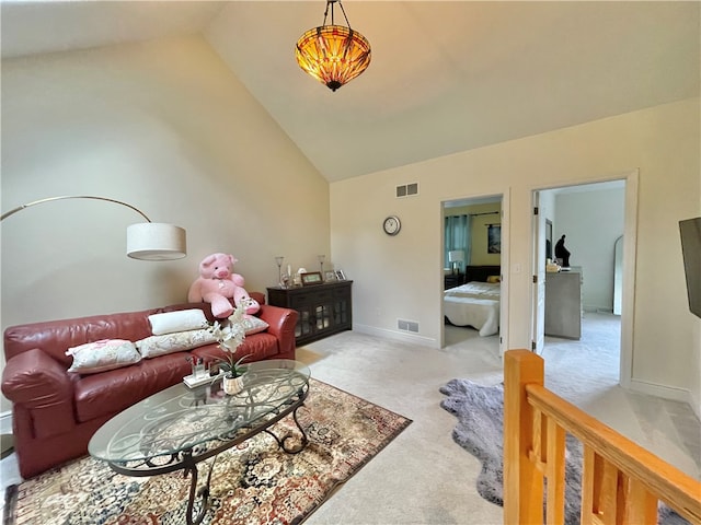 carpeted living room with vaulted ceiling