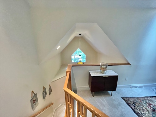 interior space featuring carpet flooring and lofted ceiling