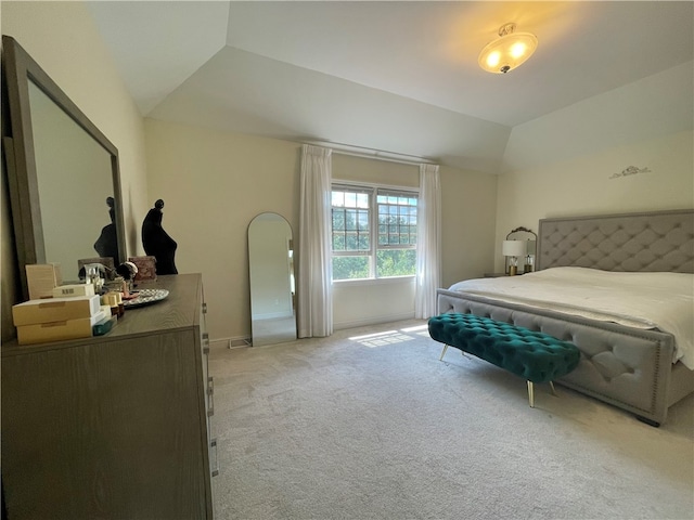 carpeted bedroom featuring lofted ceiling