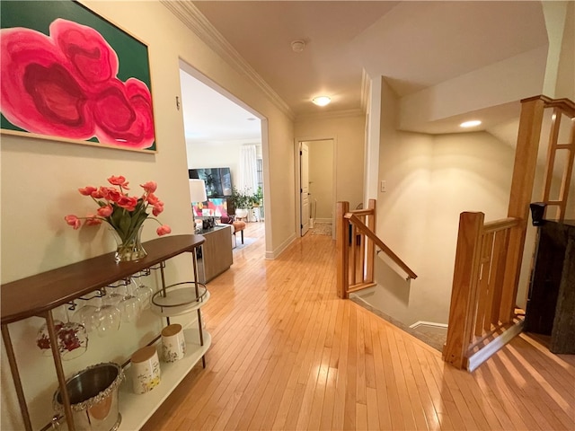 hallway featuring light hardwood / wood-style flooring and crown molding