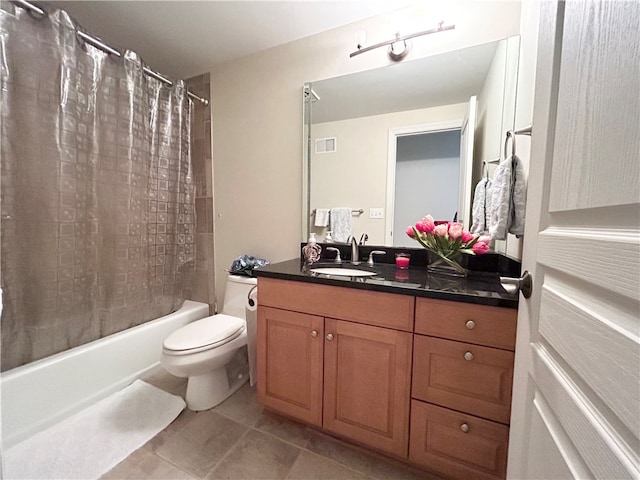 full bathroom featuring tile patterned flooring, shower / bath combination with curtain, vanity, and toilet