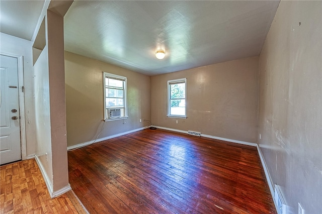 unfurnished room with hardwood / wood-style floors and cooling unit