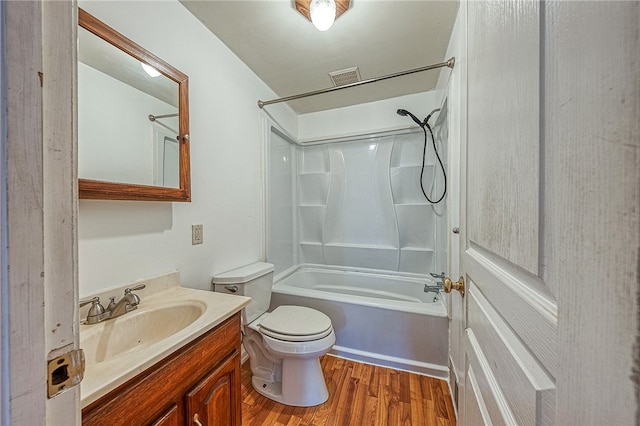 full bathroom with vanity, toilet, wood-type flooring, and washtub / shower combination