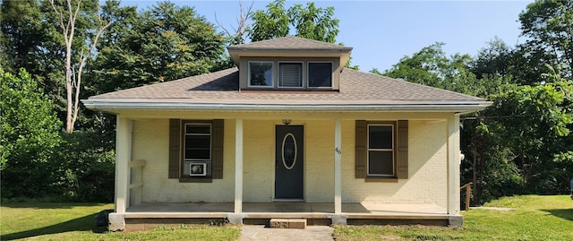 bungalow featuring a front lawn and covered porch