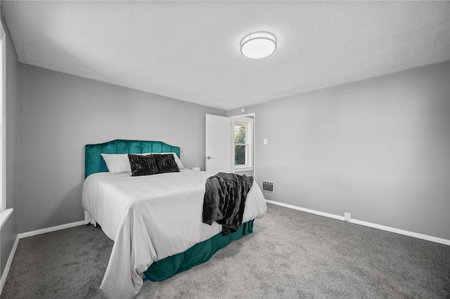 carpeted bedroom featuring a textured ceiling