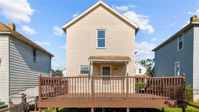 rear view of house featuring a wooden deck