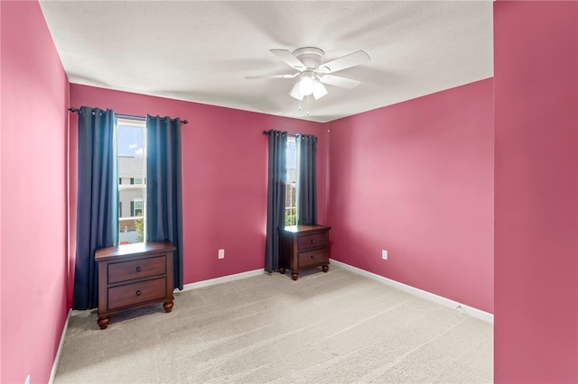 unfurnished bedroom featuring ceiling fan and light colored carpet