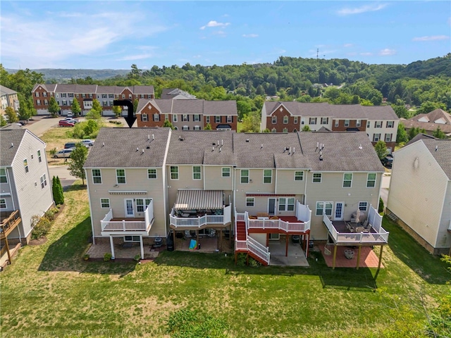 back of property with a wooden deck and a yard