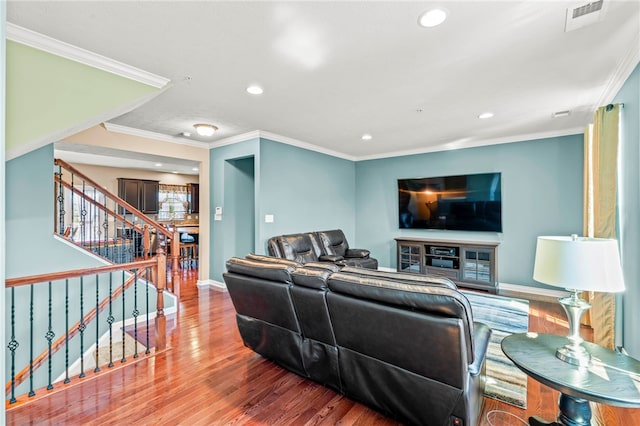 living room with crown molding and hardwood / wood-style flooring