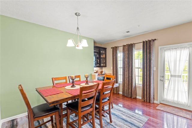 dining area featuring an inviting chandelier and wood-type flooring