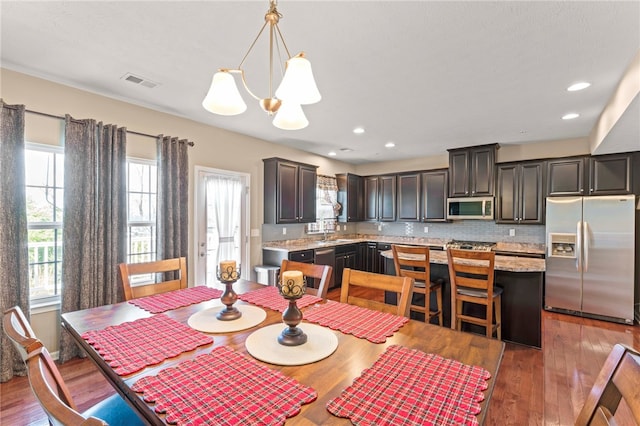 dining room with wood-type flooring and sink