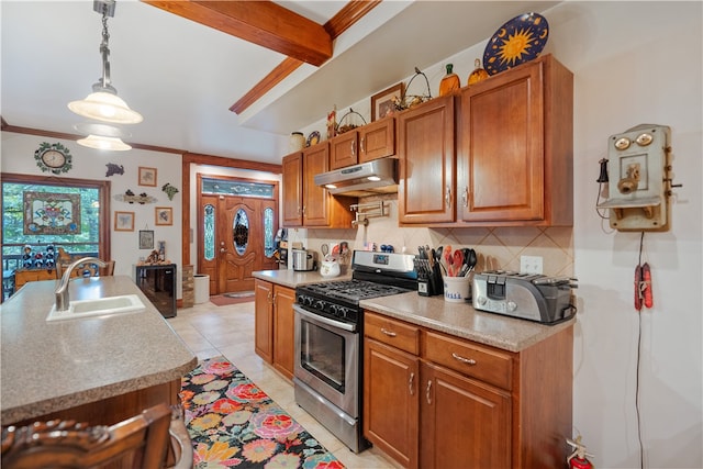 kitchen with light tile patterned floors, sink, stainless steel gas stove, and backsplash