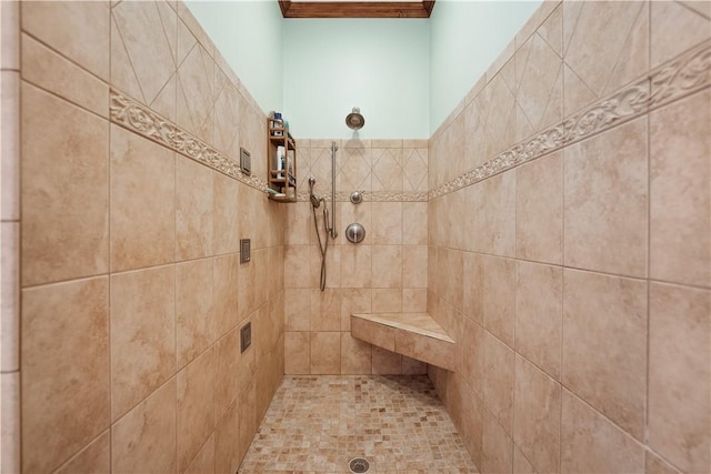 full bath with tiled shower and ornamental molding