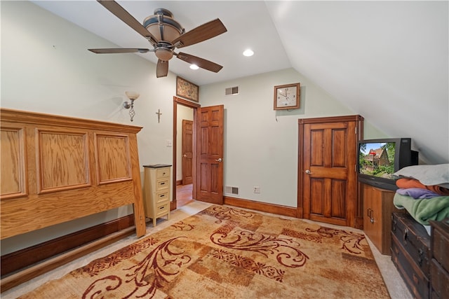 bedroom featuring lofted ceiling, light colored carpet, and ceiling fan