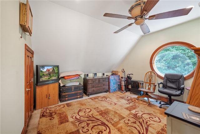 living area featuring ceiling fan, carpet flooring, and lofted ceiling