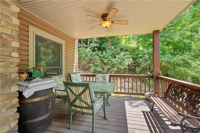 wooden deck with ceiling fan and outdoor dining space