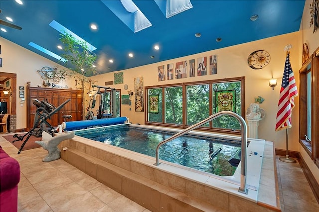 view of pool with a skylight and a hot tub