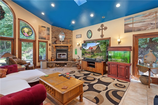 tiled living room featuring a fireplace, plenty of natural light, and high vaulted ceiling