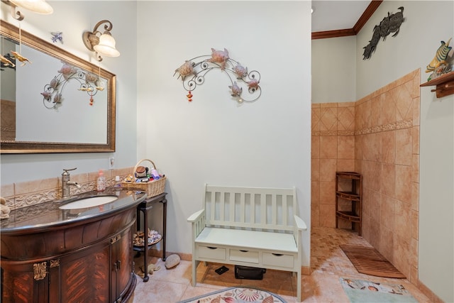 bathroom with tile walls, crown molding, tile patterned floors, and vanity