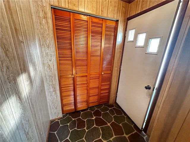 interior space featuring wooden walls and tile patterned flooring