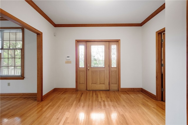 entrance foyer with light hardwood / wood-style flooring, a wealth of natural light, and crown molding