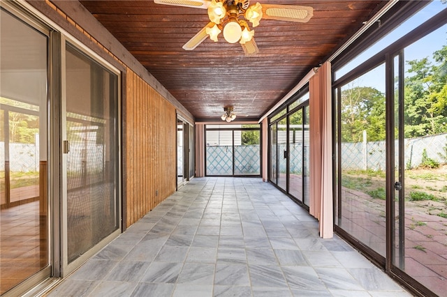 unfurnished sunroom featuring ceiling fan and wood ceiling