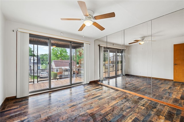 empty room with ceiling fan, wood-type flooring, and plenty of natural light