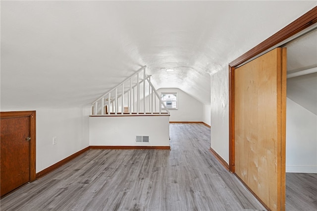 bonus room featuring light hardwood / wood-style flooring and lofted ceiling