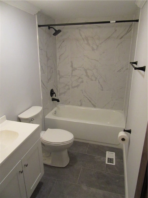 full bathroom featuring tile patterned floors, tiled shower / bath combo, vanity, and toilet