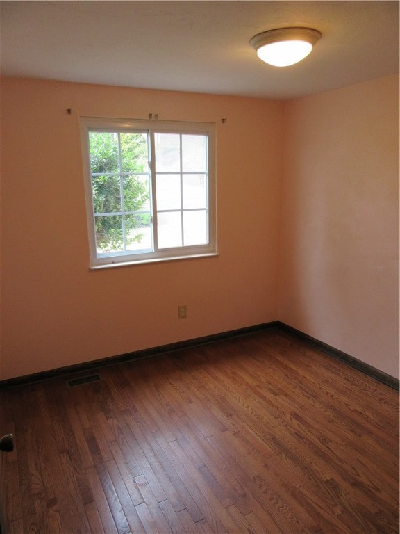 unfurnished room featuring hardwood / wood-style flooring