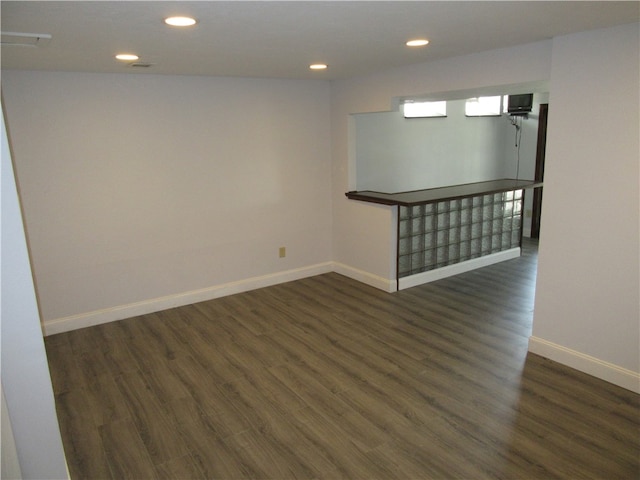 unfurnished room with dark wood-type flooring