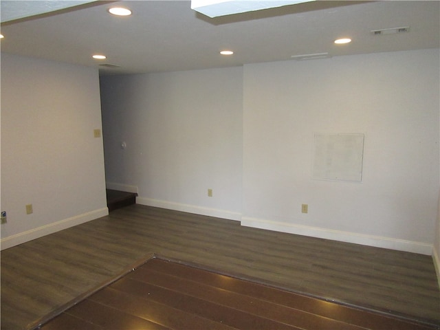 unfurnished room featuring dark wood-type flooring