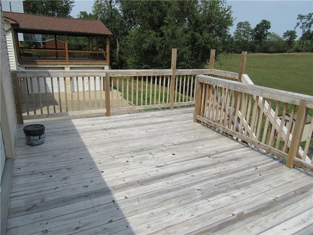 wooden terrace featuring a yard