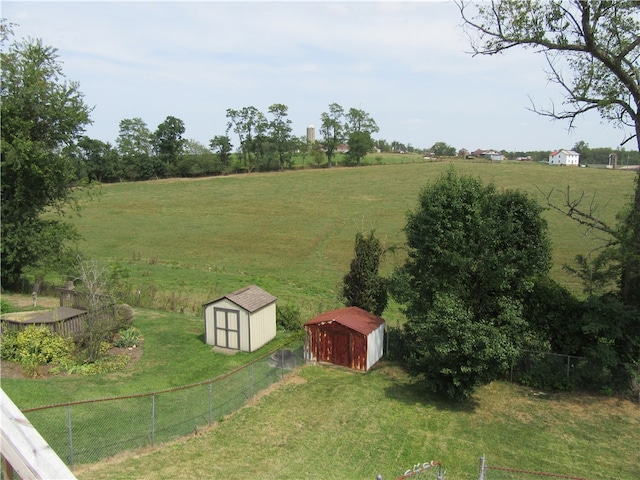 view of yard with a rural view and a storage unit