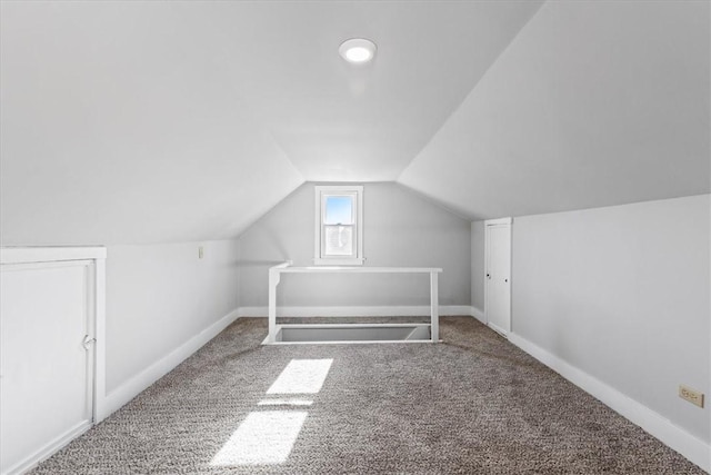 bonus room with vaulted ceiling, carpet flooring, and baseboards