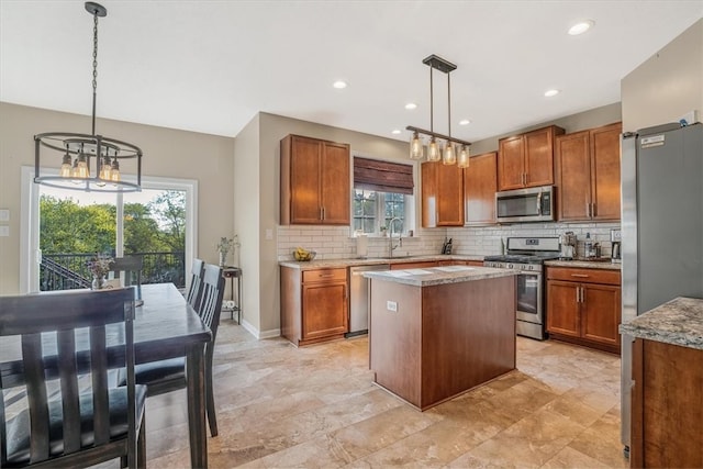 kitchen featuring backsplash, stainless steel appliances, light tile patterned floors, and hanging light fixtures