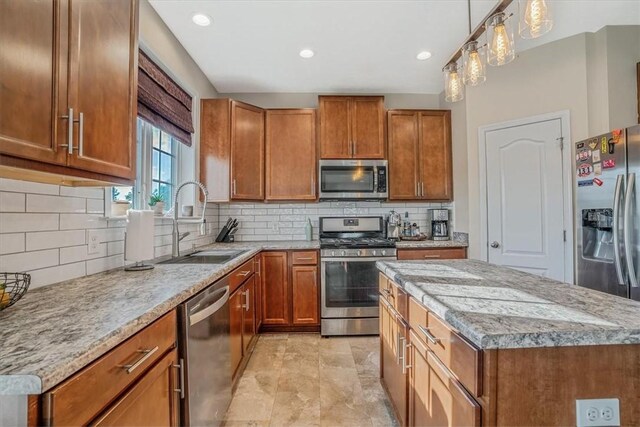 kitchen with appliances with stainless steel finishes, light tile patterned flooring, decorative light fixtures, and decorative backsplash