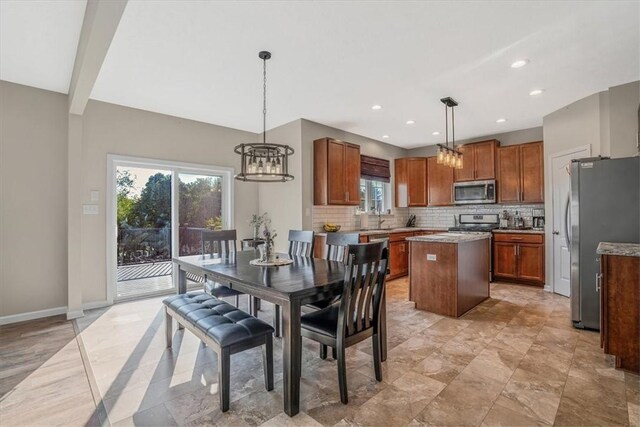 dining room featuring light tile patterned floors, sink, and an inviting chandelier