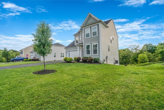 view of front of property featuring a garage and a front lawn