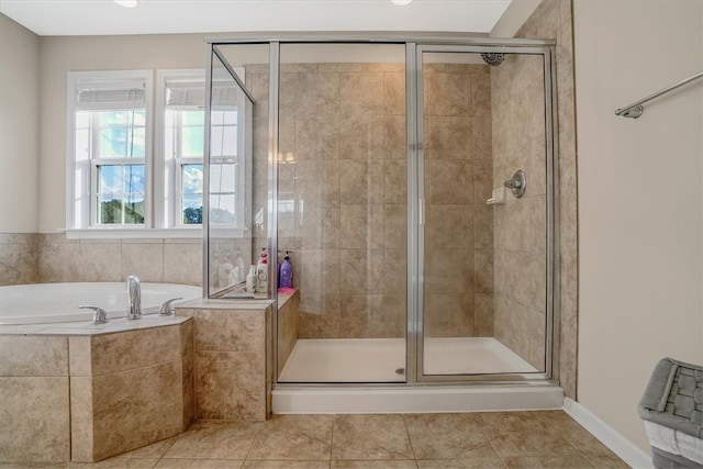 bathroom with tile patterned floors and independent shower and bath